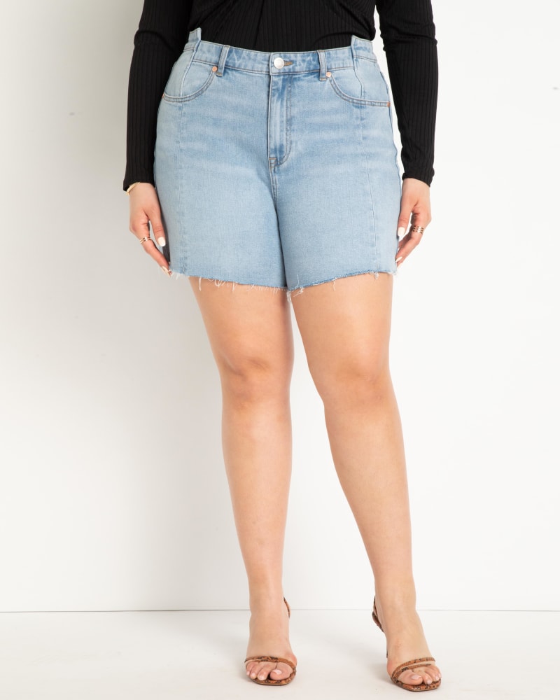 Front of a model wearing a size 28 Step Waistband Shorts in Light Wash by ELOQUII. | dia_product_style_image_id:284353